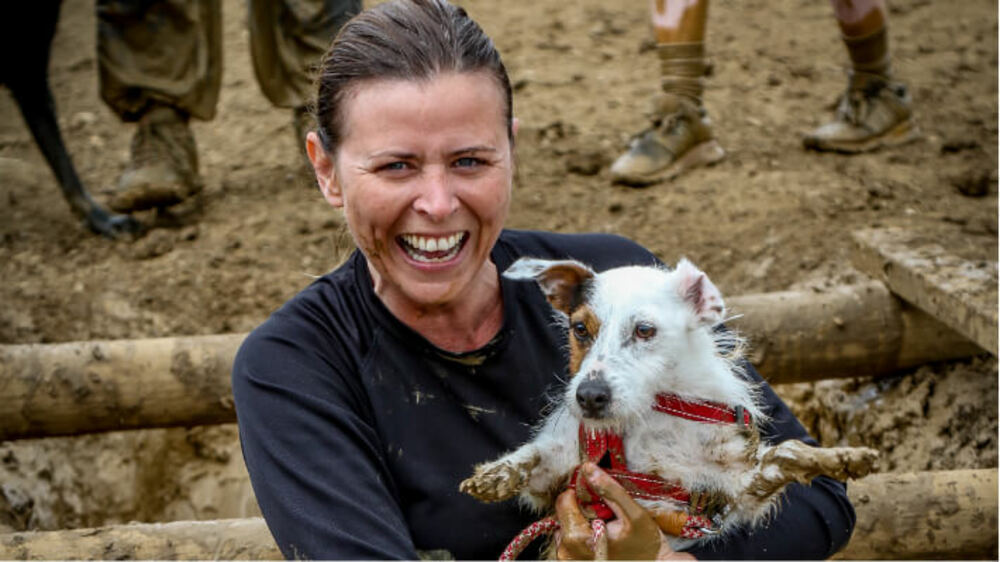 Woman with dog at the mud run