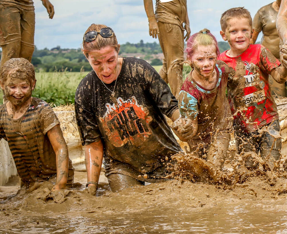 People jumping into mud